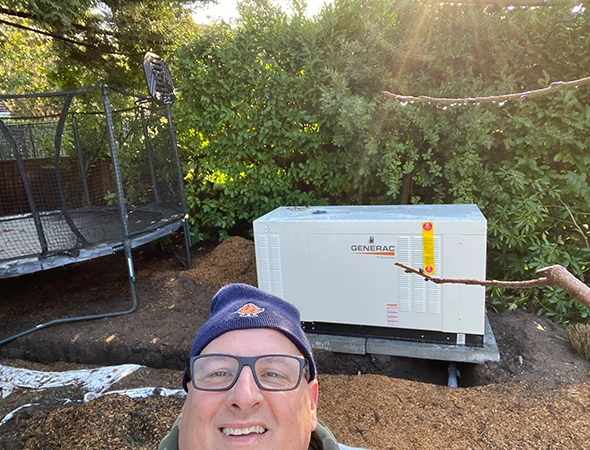 Skilled worker putting in a new backup unit as part of our generator installation services in Menlo Park.