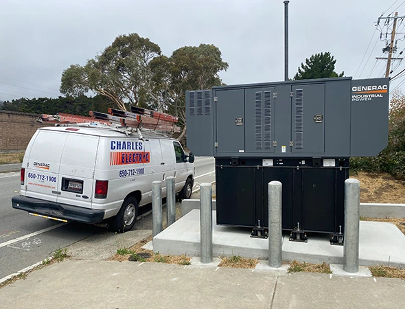 Our service van parked near a large outdoor energy system for professional hybrid backup power optimization.