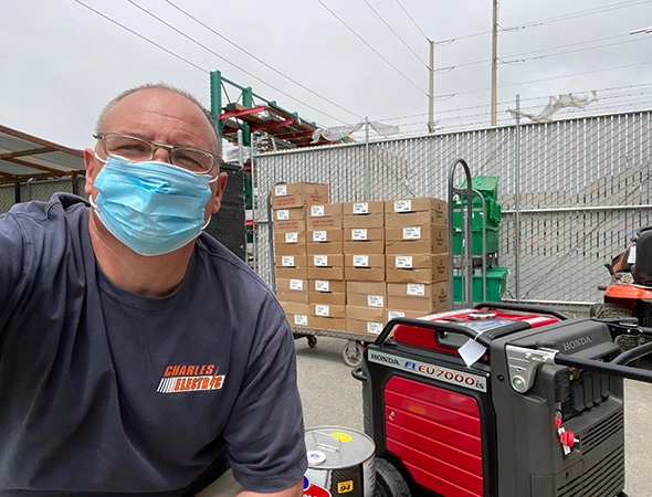 Our friendly technician wearing a blue mask while providing expert portable generator services.