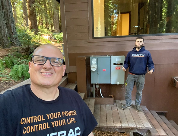 Our friendly technician smiling outdoors while setting up a custom battery backup services project.