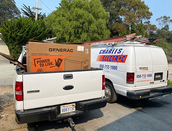Two of our service trucks parked on a residential street to finish a standby generator installation in Woodside.
