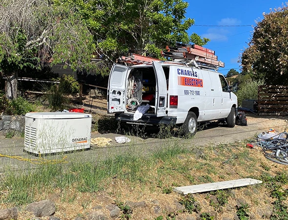Our service van parked on a residential property near a newly placed unit for a whole-home generator installation.