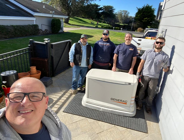 Our friendly group of technicians standing behind a finished unit after a whole home generator installation in Portola Valley.
