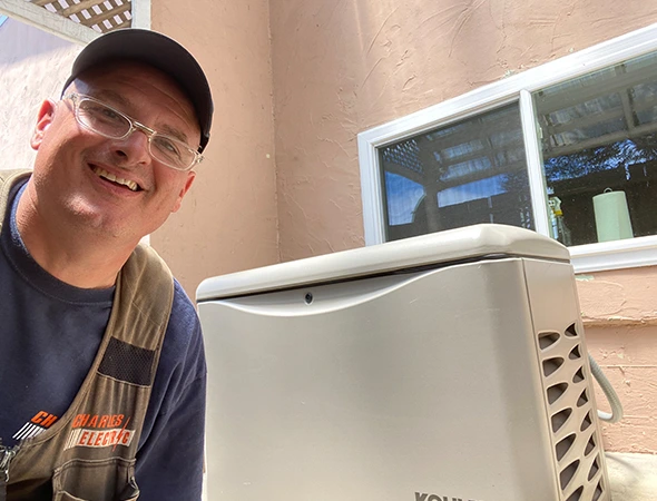 Inside an Atherton home, our team inspects the generator battery and electrical connections.