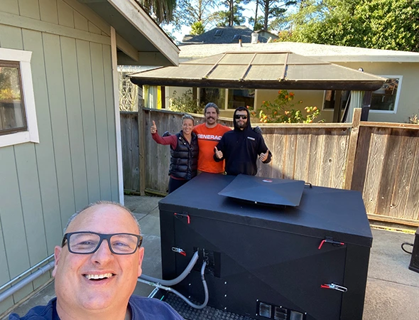 Standing in an Emerald Hills backyard, our specialists prepare to install a new battery and generator combo.