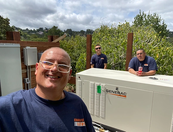 Two technicians working together in Emerald Hills to integrate solar panels with a modern backup system.