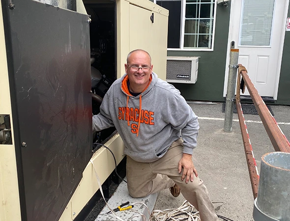 A close-up of our expert technician kneeling by a versatile portable unit at an Emerald Hills home.