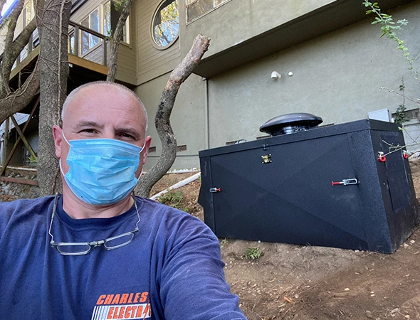 A specialist wearing a blue protective mask while finalizing a whole-home power upgrade in Emerald Hills.