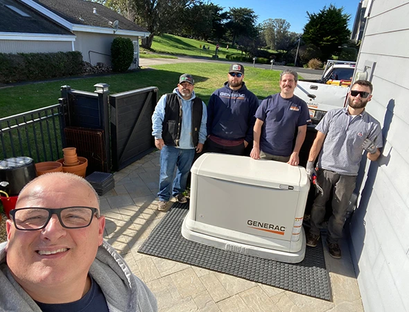 Our team gathered in a Hillsborough backyard after finishing a custom Kohler backup system installation.