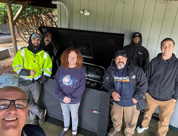 Our Los Altos team gathered around a large generator unit after successfully completing a complex repair.