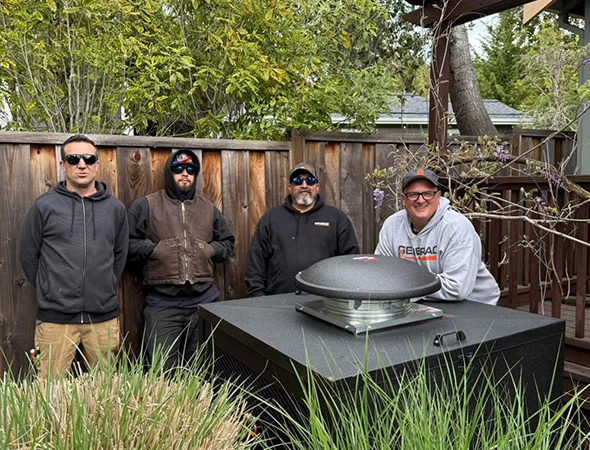 Three of our specialists standing together in a Los Altos backyard next to a freshly serviced standby unit.