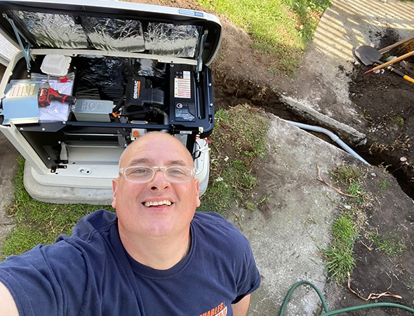 A high-angle view of our technician checking the internal components of a generator during an emergency Los Altos call.