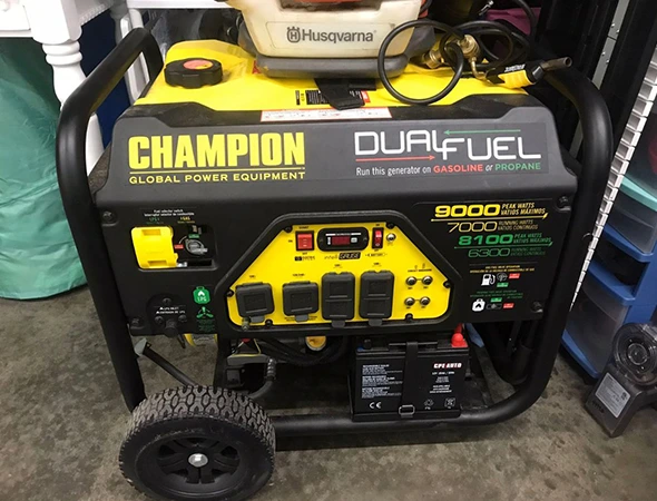 Our specialist in Portola Valley checking the engine and wheels of a yellow Champion generator.