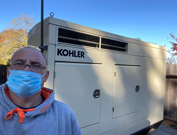 A San Carlos specialist wearing a blue mask while checking on a large standby unit.