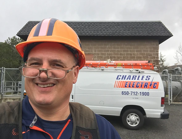 One of our workers in a hard hat standing by the service van before a San Carlos job.