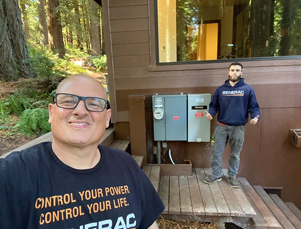 Our technician in a Charles Electric shirt finishing a battery installation project in Woodside.
